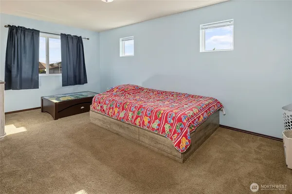 a bedroom with a bed and window