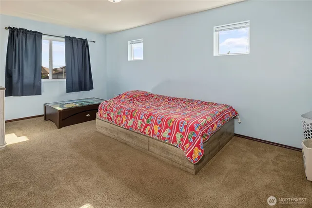 a bedroom with a bed and window