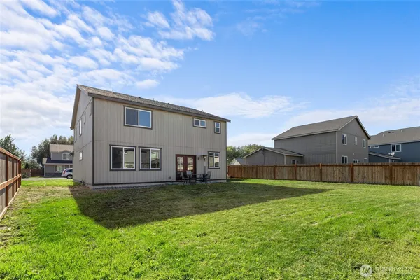 a view of house with a big yard