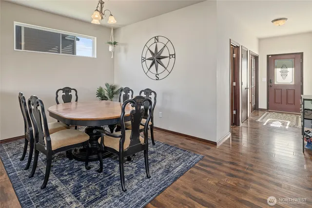 a view of a dining room with furniture wooden floor and a chandelier