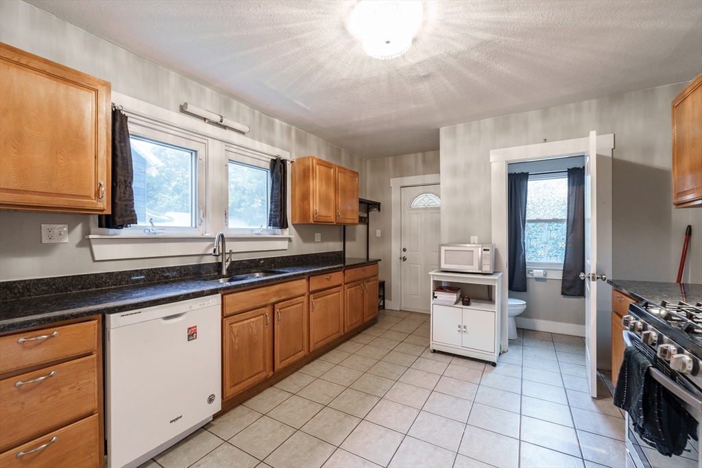 71 Daviston Street Springfield, MA 01108 - Photo 12 of 32 a large white kitchen with cabinets