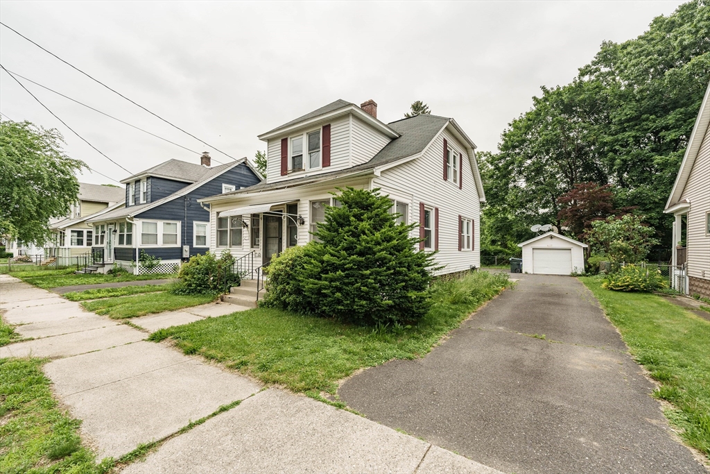 71 Daviston Street Springfield, MA 01108 - Photo 2 of 32 a front view of a house with a yard and trees
