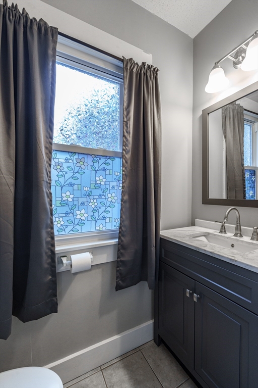 71 Daviston Street Springfield, MA 01108 - Photo 23 of 32 a bathroom with a double vanity sink and a bathtub