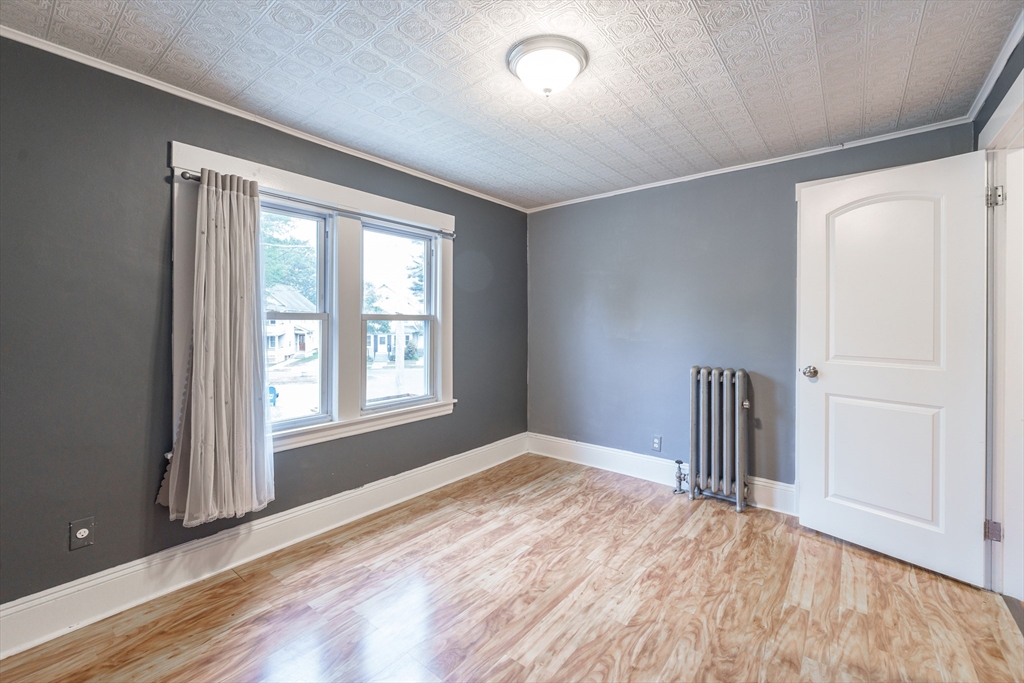 71 Daviston Street Springfield, MA 01108 - Photo 25 of 32 a view of empty room with wooden floor and fan