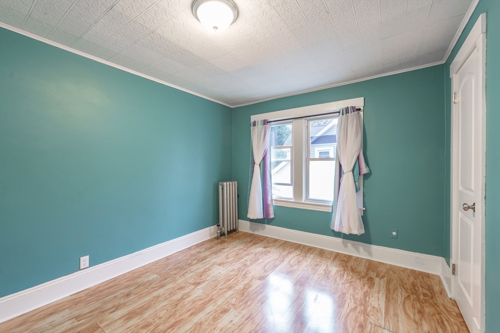 71 Daviston Street Springfield, MA 01108 - Photo 26 of 32 an empty room with wooden floor and windows