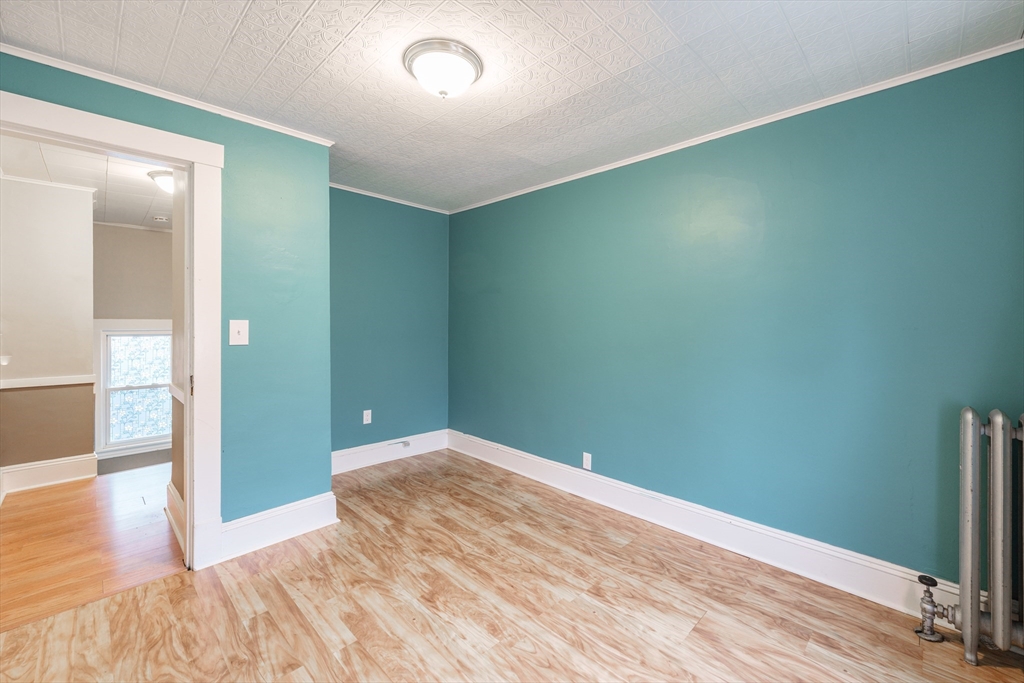 71 Daviston Street Springfield, MA 01108 - Photo 27 of 32 an empty room with wooden floor and entrance