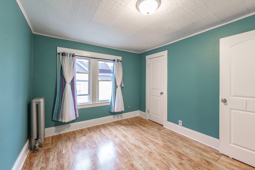 71 Daviston Street Springfield, MA 01108 - Photo 28 of 32 a view of empty room with wooden floor and fan