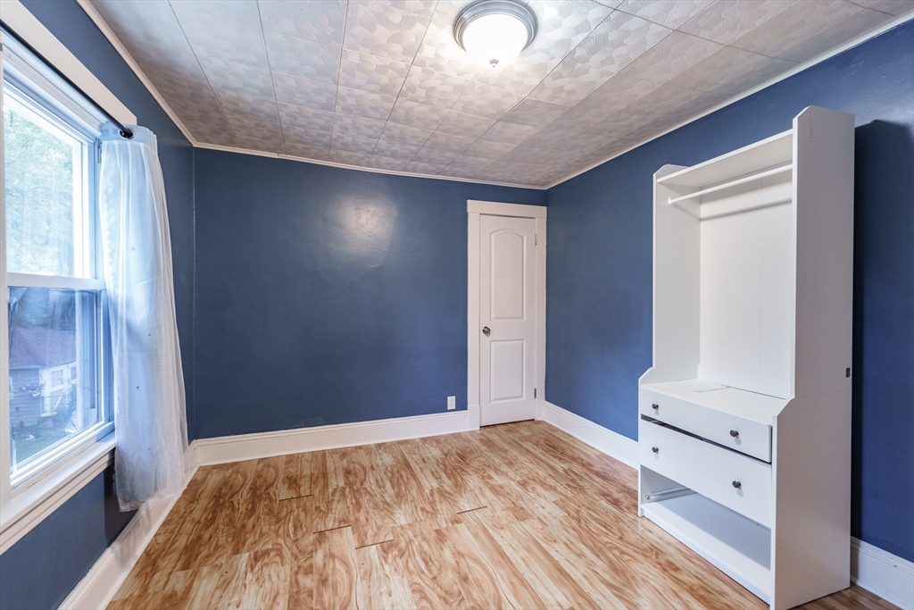 71 Daviston Street Springfield, MA 01108 - Photo 29 of 32 a view of empty room with wooden floor and fan