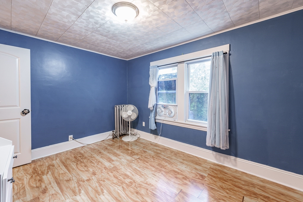 71 Daviston Street Springfield, MA 01108 - Photo 31 of 32 a view of empty room with wooden floor and fan