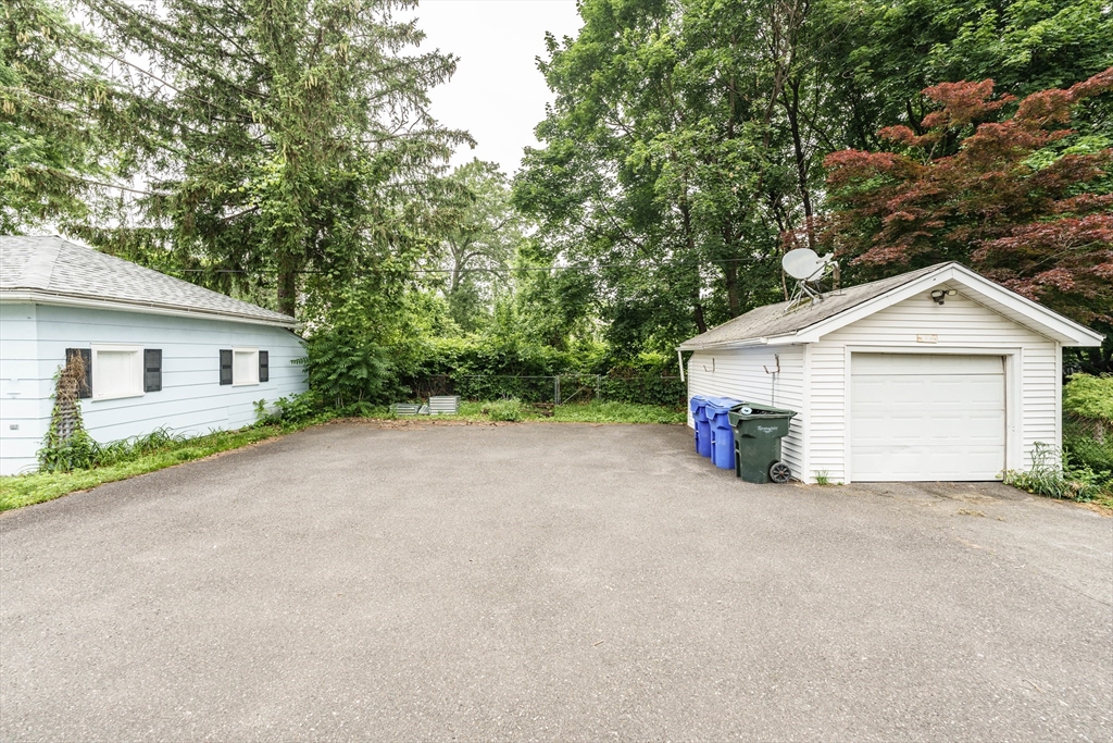 71 Daviston Street Springfield, MA 01108 - Photo 7 of 32 a view of a house with a yard and garage