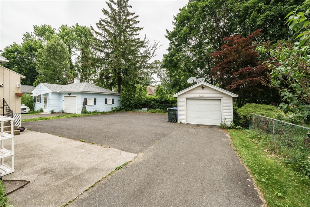 71 Daviston Street Springfield, MA 01108 - Photo 8 of 32 a front view of a house with a yard and garage