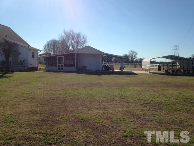 Enjoy the deck , yard, screened in porch, outbuilding, concrete and shelter...WOW