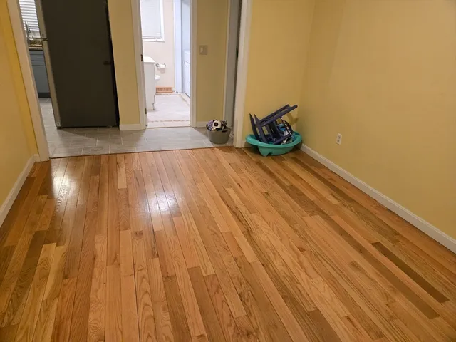 a view of a room with wooden floor