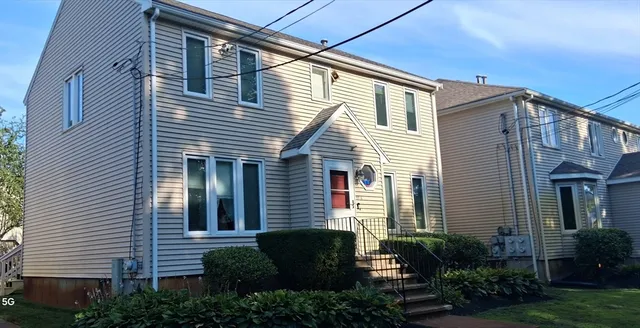a view of a house with a backyard