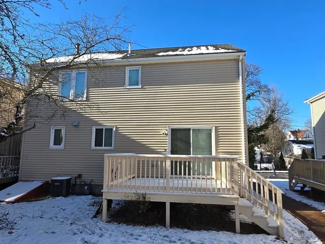 a view of a house with a small deck and a yard