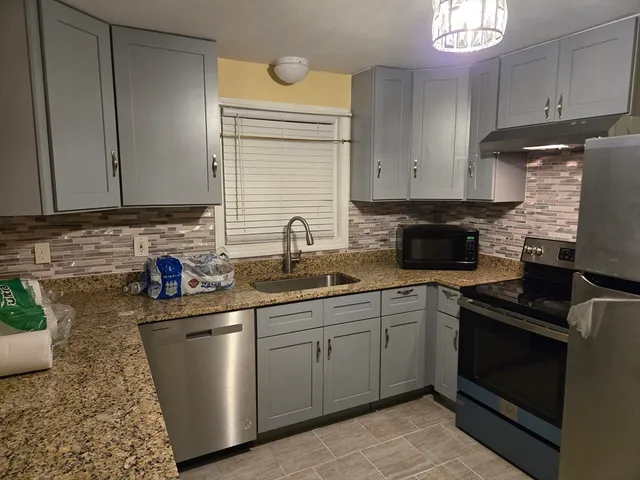 a kitchen with a sink and cabinets
