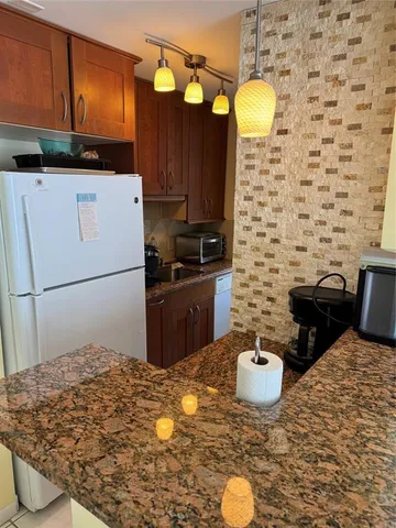 a kitchen with a sink a stove and refrigerator
