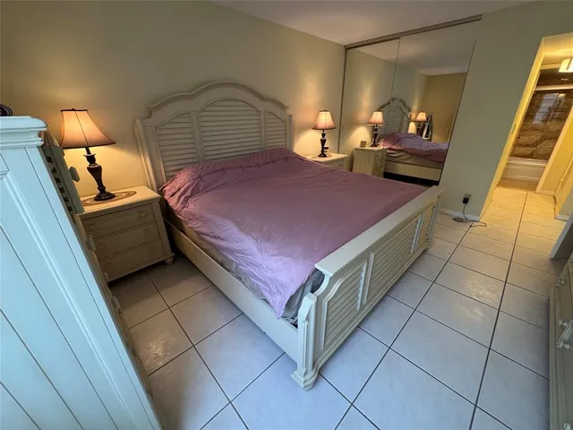 a bedroom with a bed and a mirror