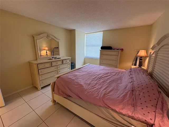 a bedroom with a bed and a mirror