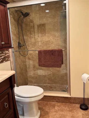 a bathroom with a toilet and a shower