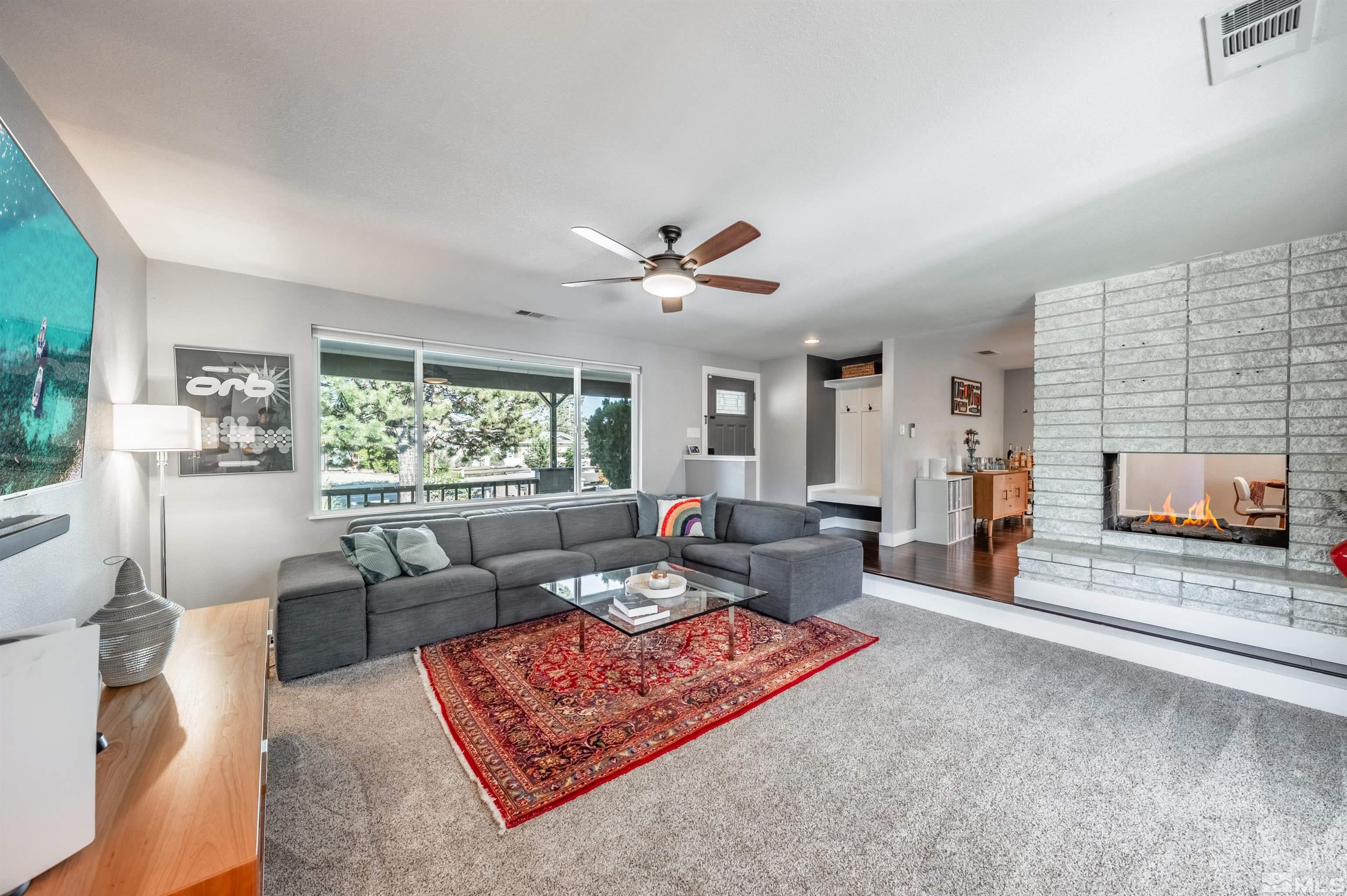 3901 Warren Way Reno, NV 89509 - Photo 12 of 40 a living room with furniture and a fireplace