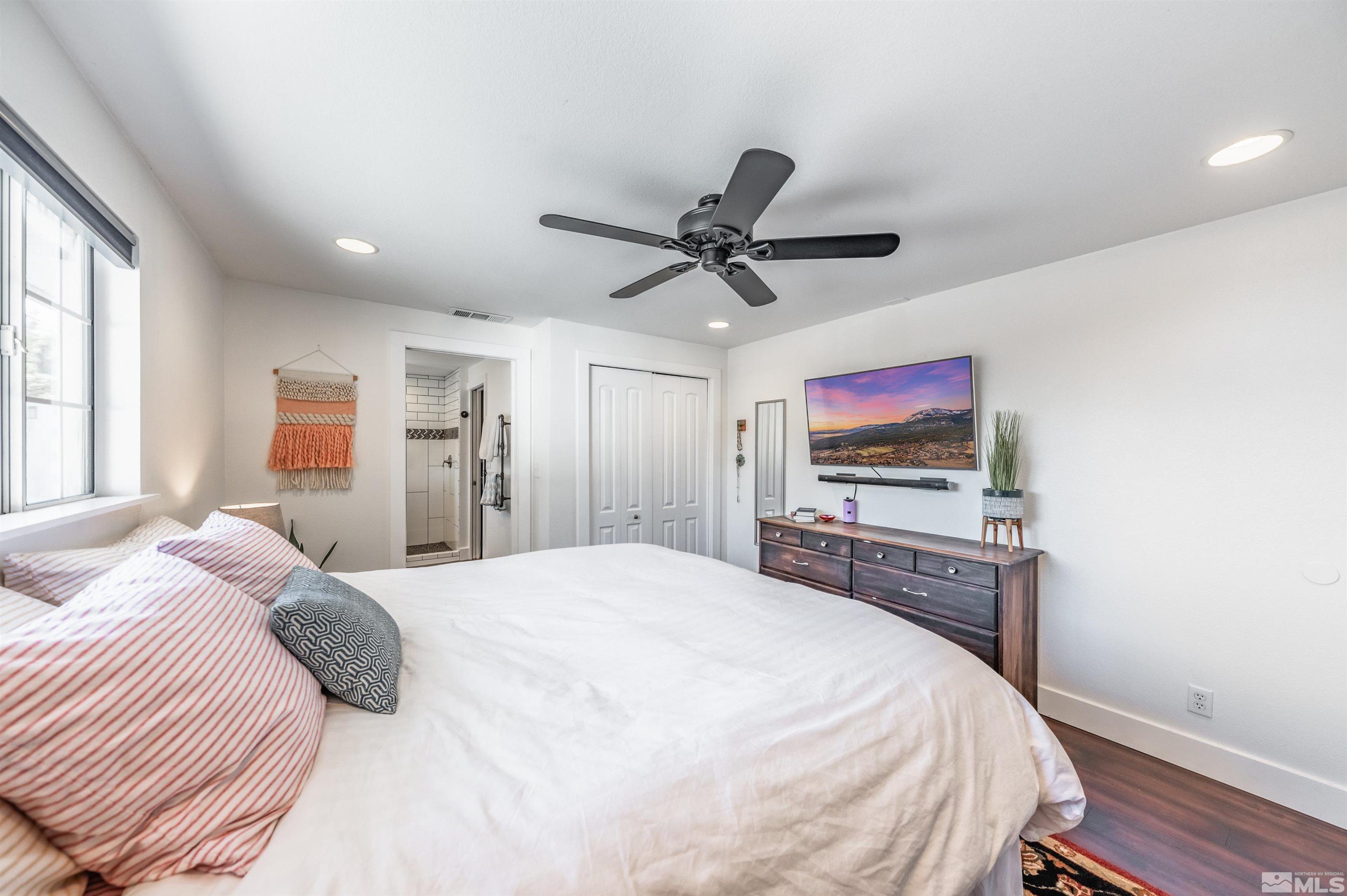 3901 Warren Way Reno, NV 89509 - Photo 19 of 40 a bedroom with a bed and a flat screen tv