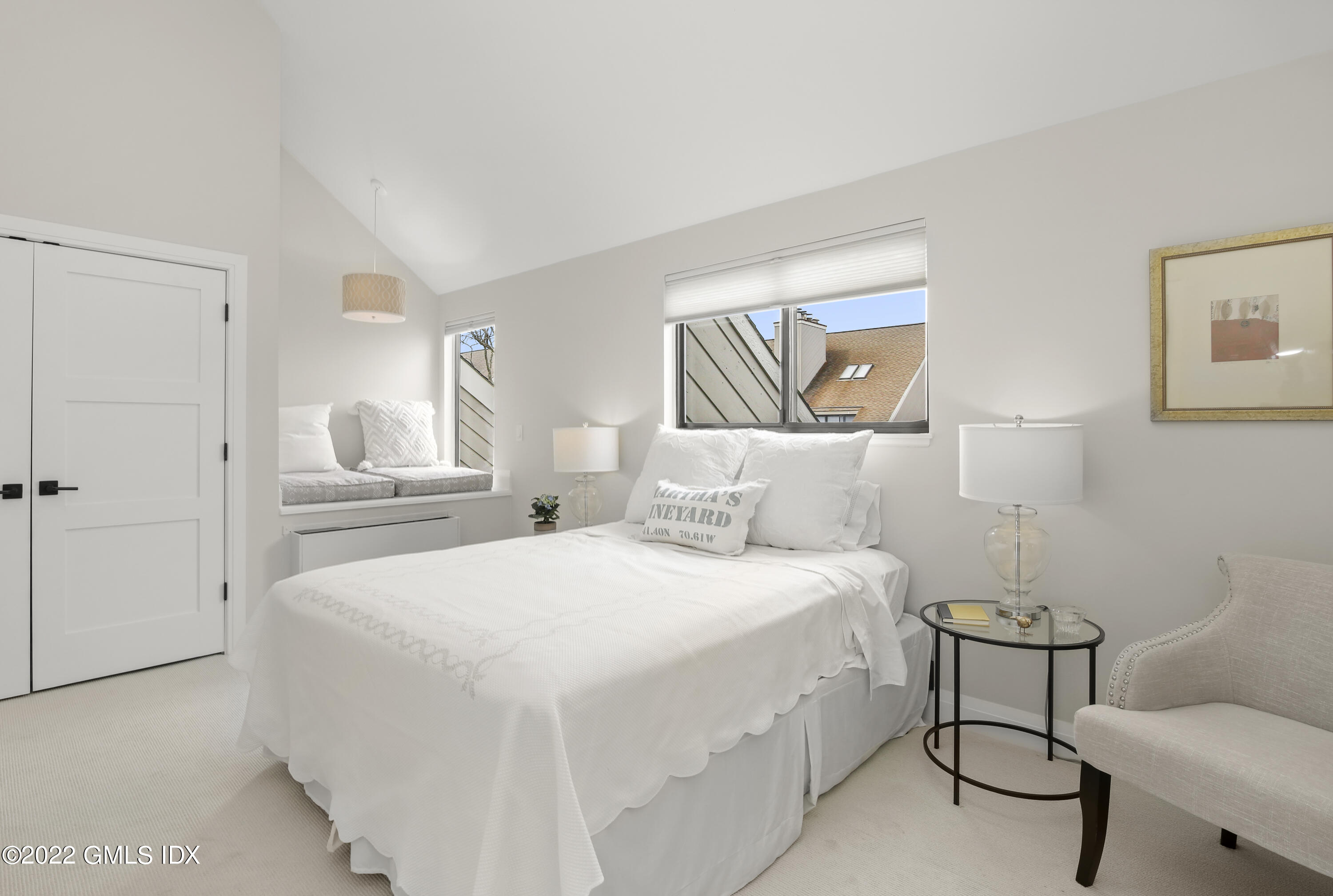 15 River Road, Unit 213 Cos Cob, CT 06807 - Photo 15 of 20 a bedroom with a bed and a chair