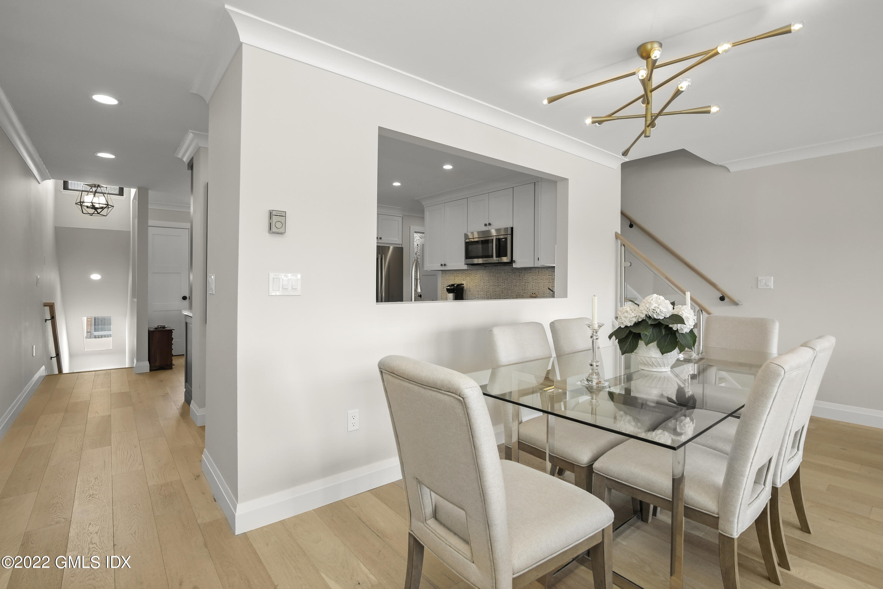 15 River Road, Unit 213 Cos Cob, CT 06807 - Photo 3 of 20 a view of a dining room with furniture and wooden floor