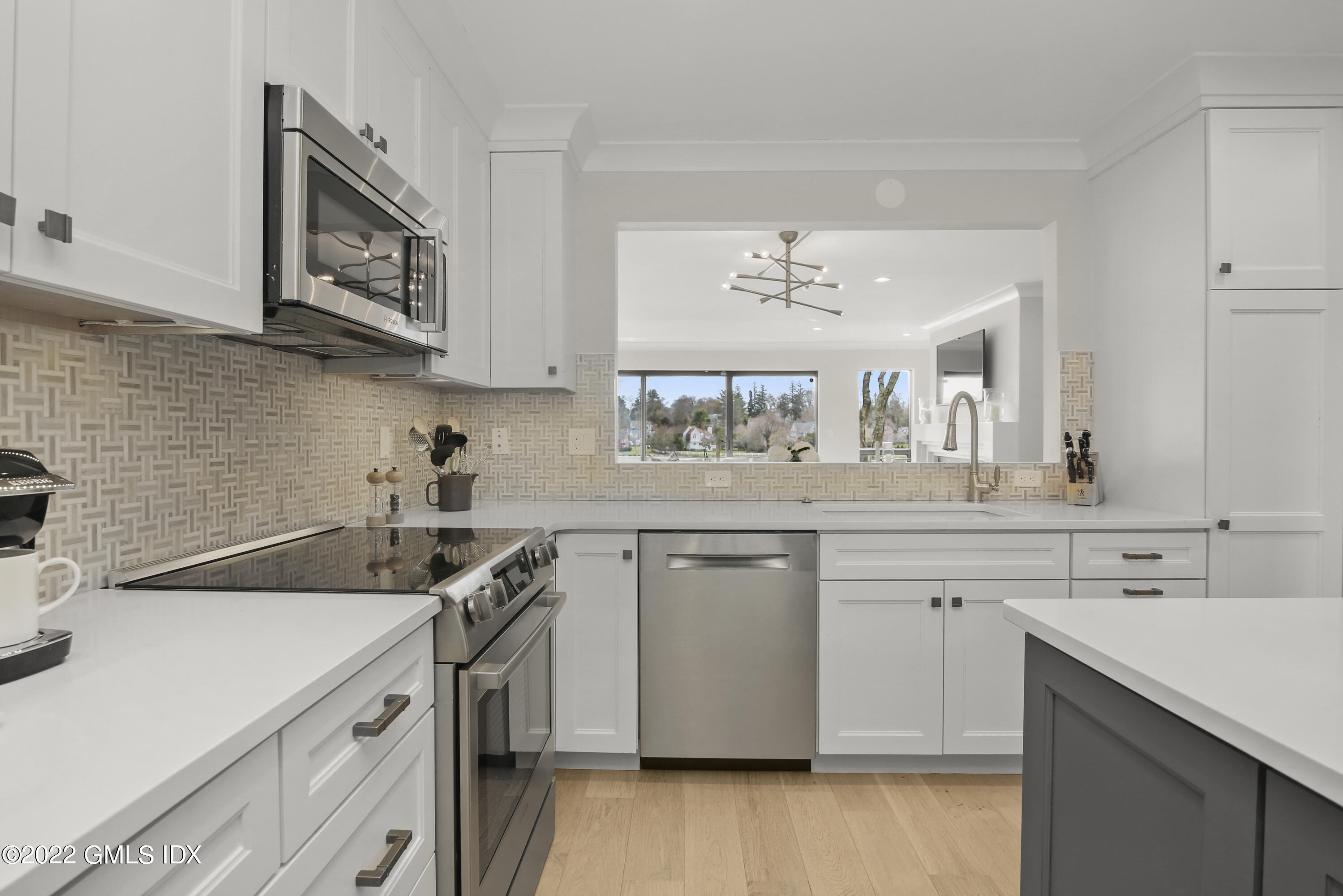 15 River Road, Unit 213 Cos Cob, CT 06807 - Photo 4 of 20 a kitchen with a sink cabinets and appliances