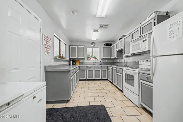 a kitchen with a sink a stove top oven and cabinets