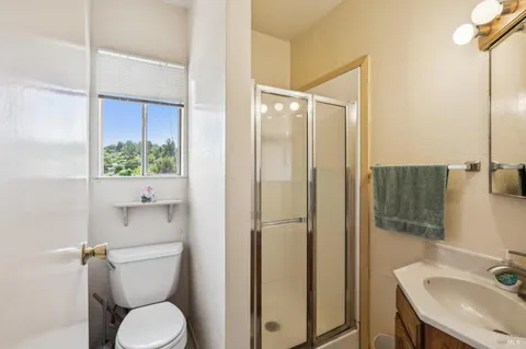 a bathroom with a toilet a sink and shower
