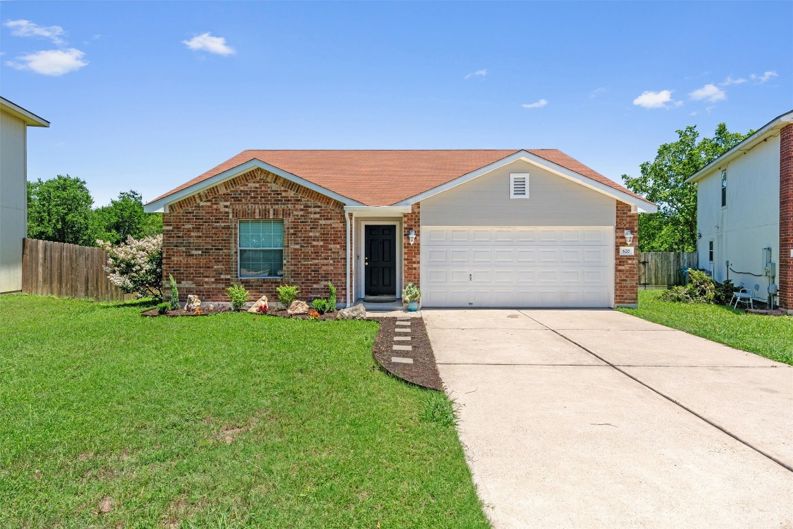 620 Lavaca Loop Elgin, TX 78621 - Photo 1 of 1 a front view of a house with a garden