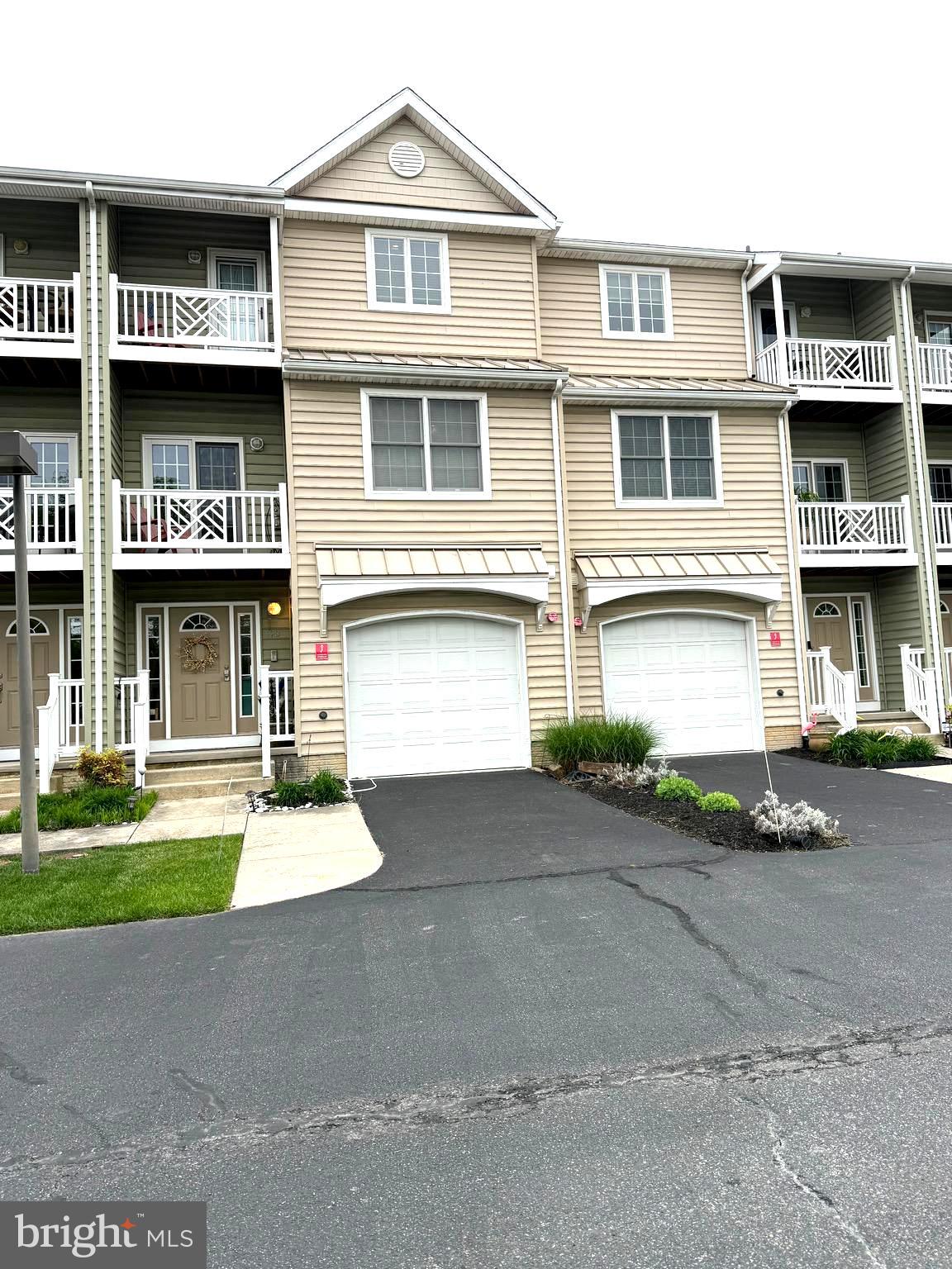 9823 Golf Course Road, Unit 20 Ocean City, MD 21842 - Photo 1 of 61 a front view of houses with yard