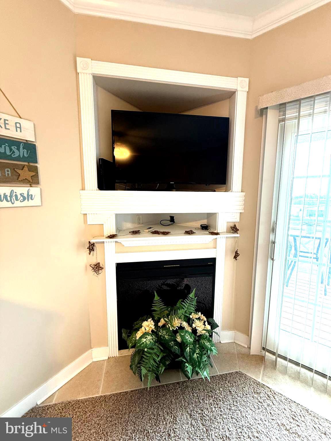 9823 Golf Course Road, Unit 20 Ocean City, MD 21842 - Photo 18 of 61 Corner Fireplace and TV setup