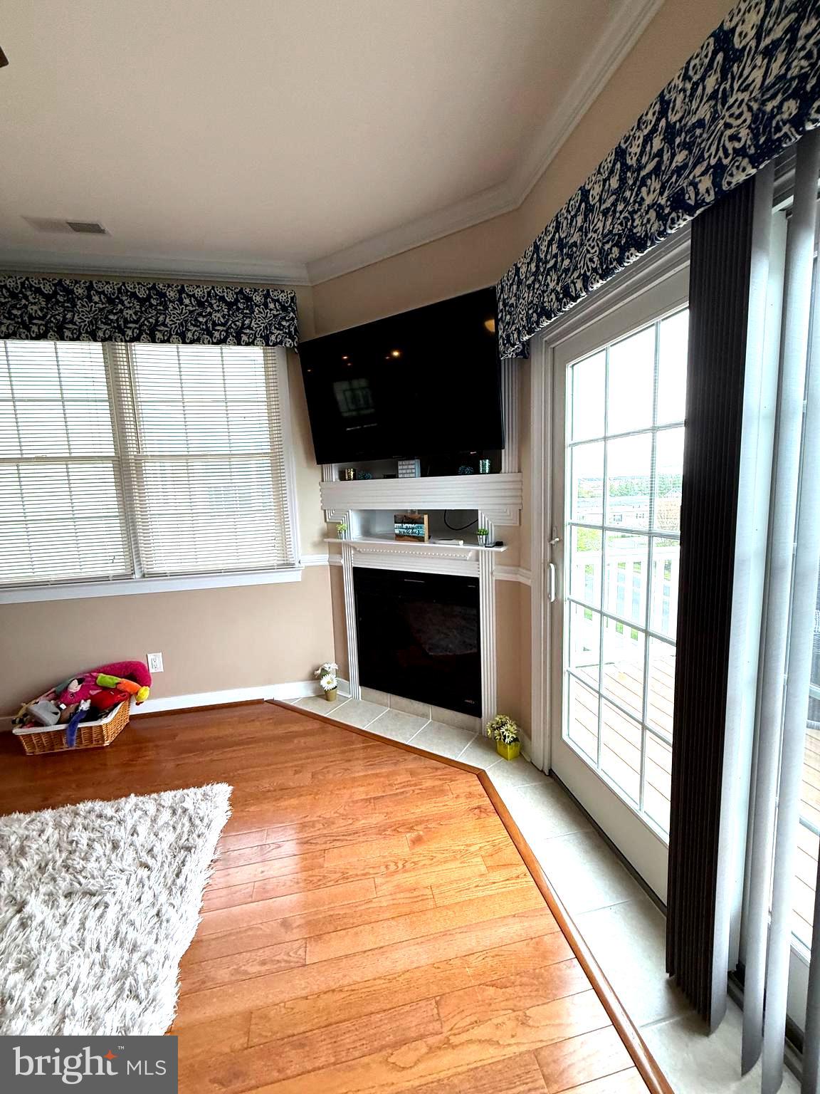 9823 Golf Course Road, Unit 20 Ocean City, MD 21842 - Photo 27 of 61 a living room with a large fireplace and a flat screen tv