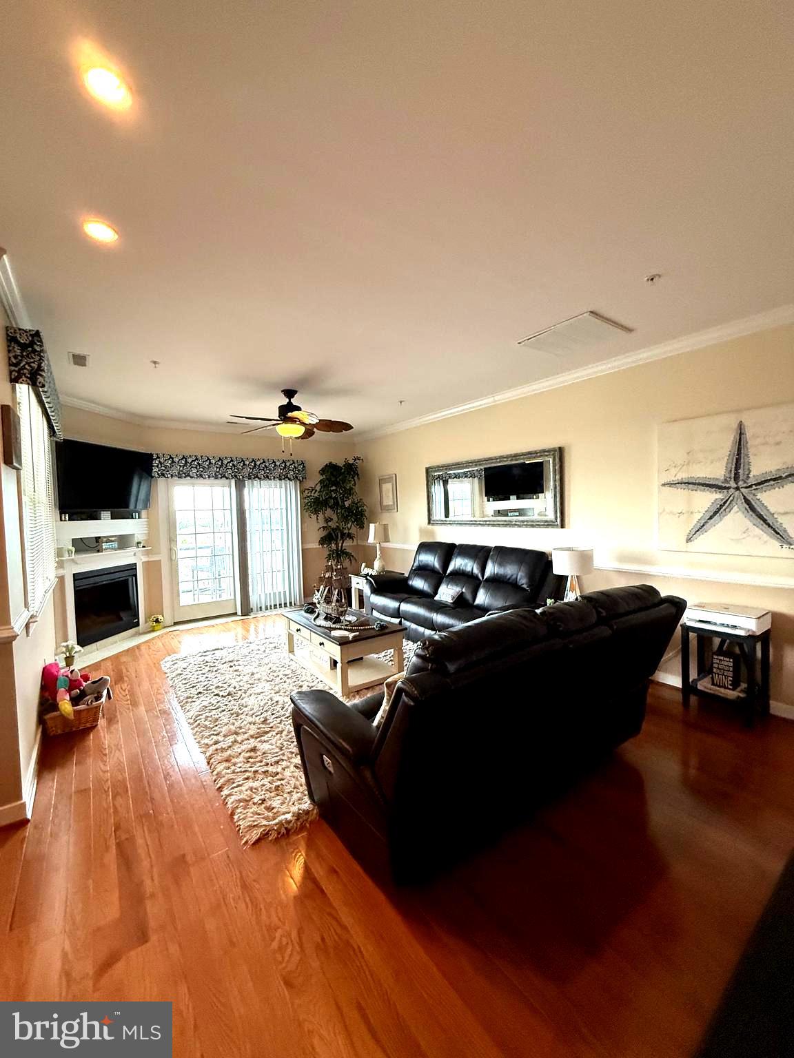 9823 Golf Course Road, Unit 20 Ocean City, MD 21842 - Photo 29 of 61 a living room with furniture and a flat screen tv