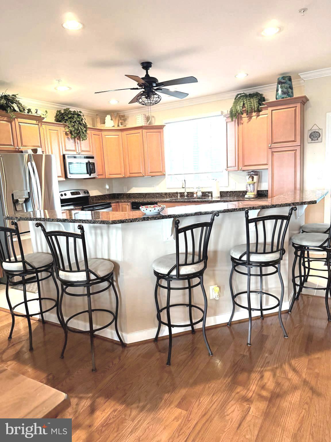 9823 Golf Course Road, Unit 20 Ocean City, MD 21842 - Photo 30 of 61 a kitchen with a table chairs stove and sink