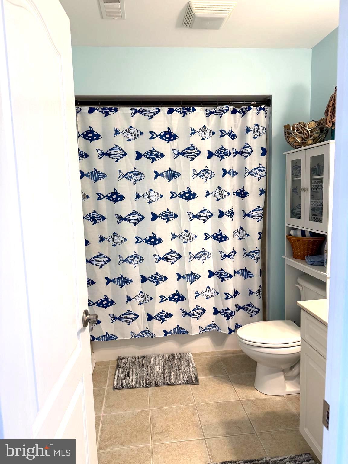 9823 Golf Course Road, Unit 20 Ocean City, MD 21842 - Photo 56 of 61 a bathroom with a toilet and a shower curtain