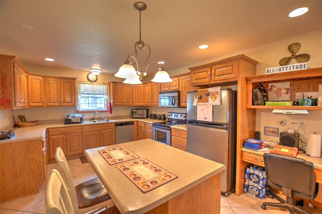 2008 St Louis Bridge Road Decatur, IL 62521 - Photo 18 of 36 a kitchen with a refrigerator a stove top oven a sink dishwasher and white cabinets with wooden floor