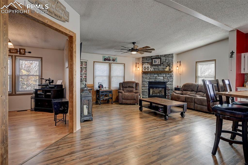 35355 Funk Road Calhan, CO 80808 - Photo 15 of 31 a living room with fireplace furniture and a wooden floor