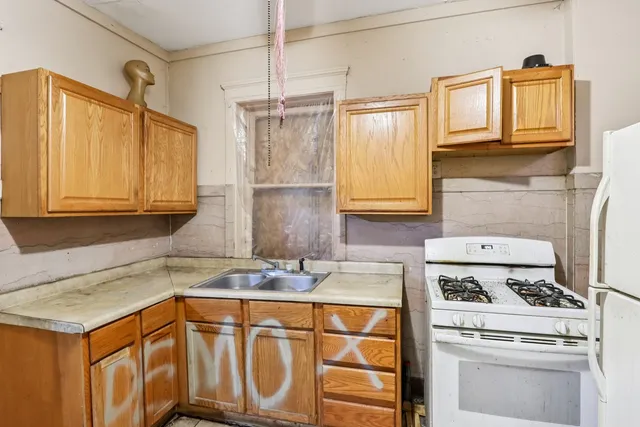 a bathroom with a granite countertop sink a mirror and a shower