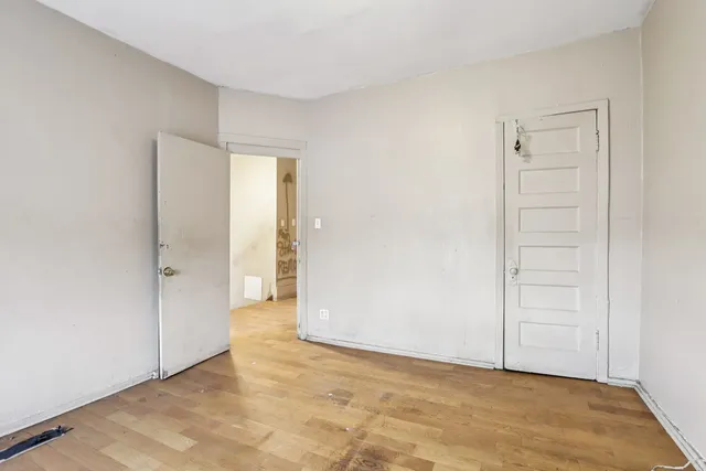 an empty room with windows and closet