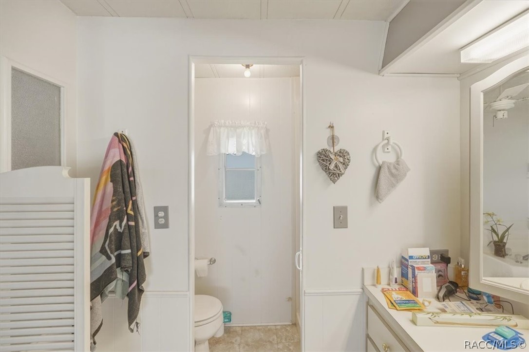928 South Shad Terrace Inverness, FL 34450 - Photo 21 of 48 a bathroom with a sink a toilet and shower curtain