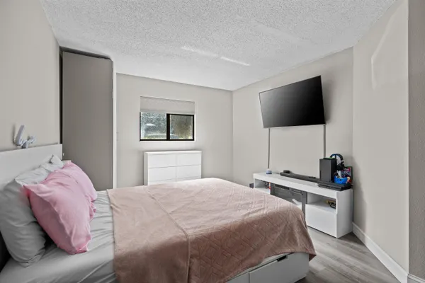 a bedroom with a bed and a flat screen tv