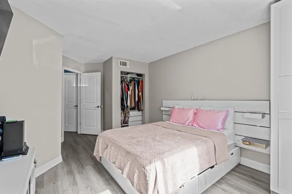 a bedroom with a bed and a flat screen tv