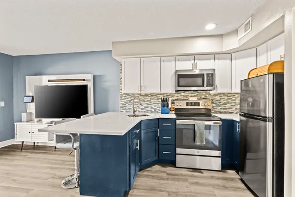 a kitchen with a refrigerator stove and microwave