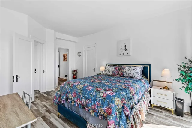 a bedroom with a bed and a potted plant