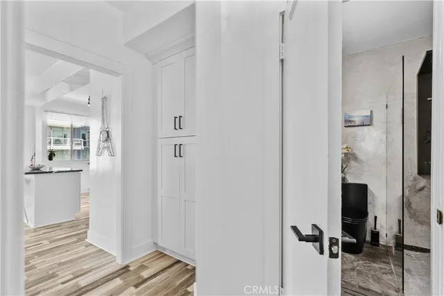 a view of a room with gym equipment and wooden floor