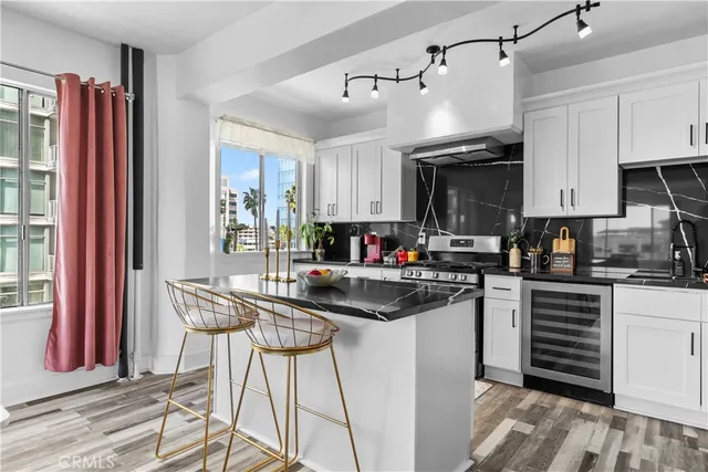 a kitchen with stainless steel appliances kitchen island granite countertop a sink and cabinets