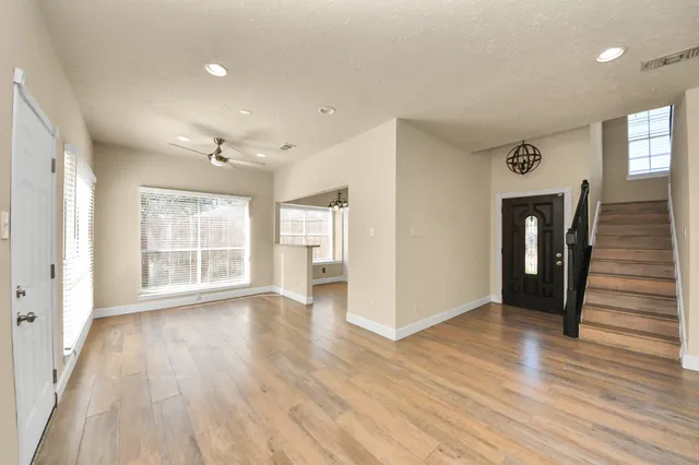 wooden floor in an empty room with a window